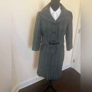 Size 8, women’s two piece polyester suit. This material is light weight.